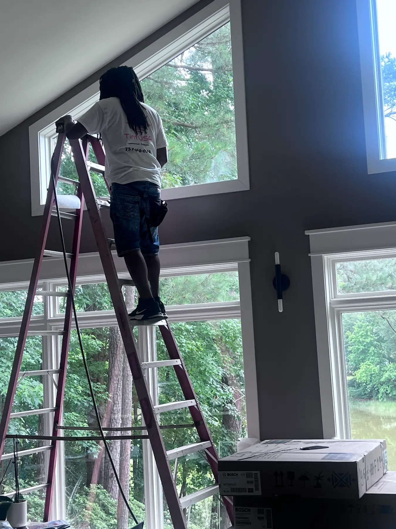 Window tint installation in progress at a Virginia Beach home.
